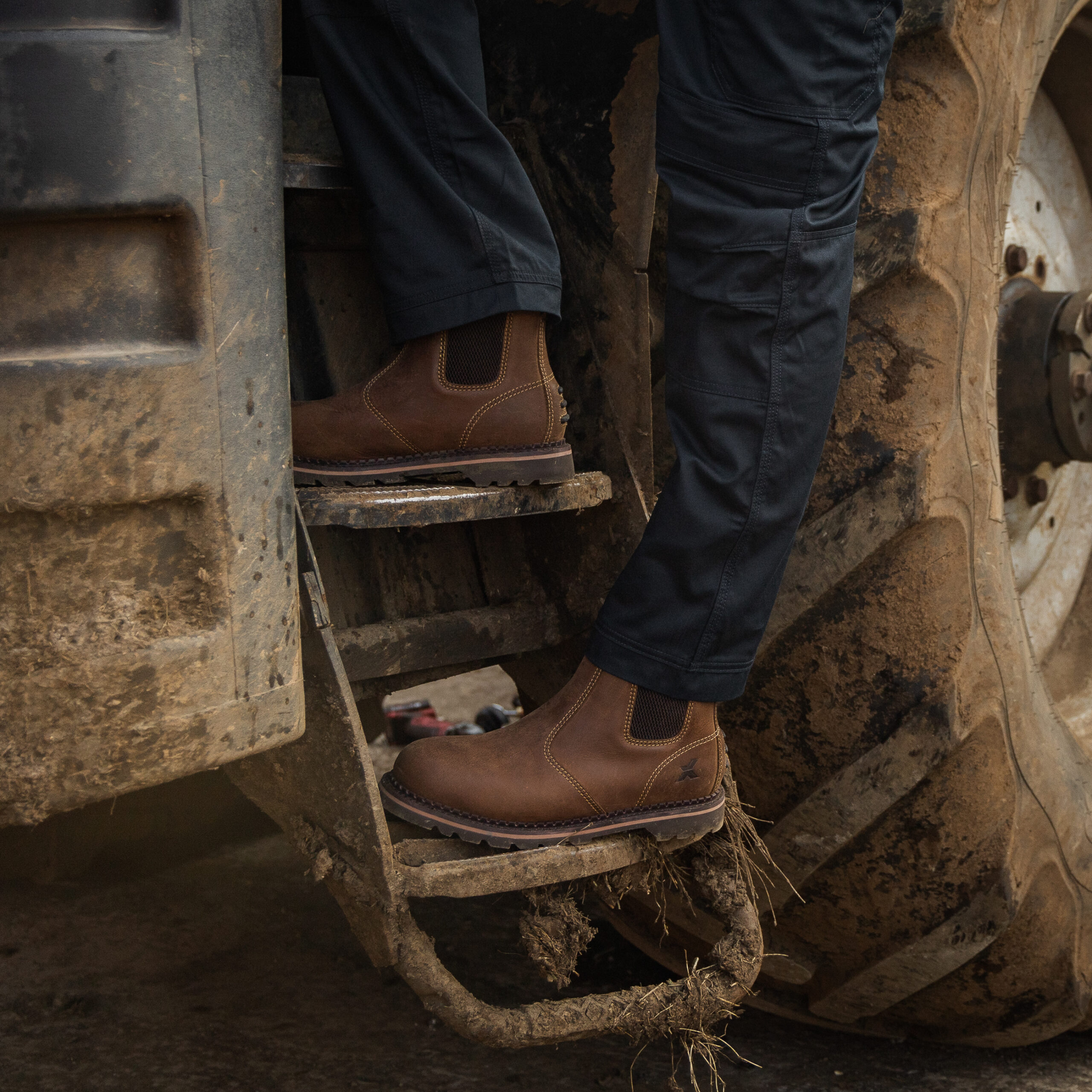 Brown Xpert dealer boots worn while working on a farm